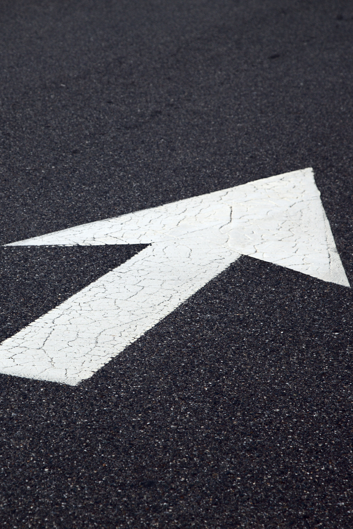 an arrow painted on the road, pointing forward